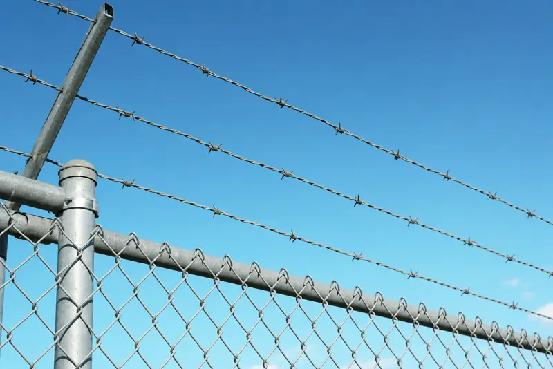 Commercial Chain Link Fence with Barbed Wire Topper Installed in Houston, TX
