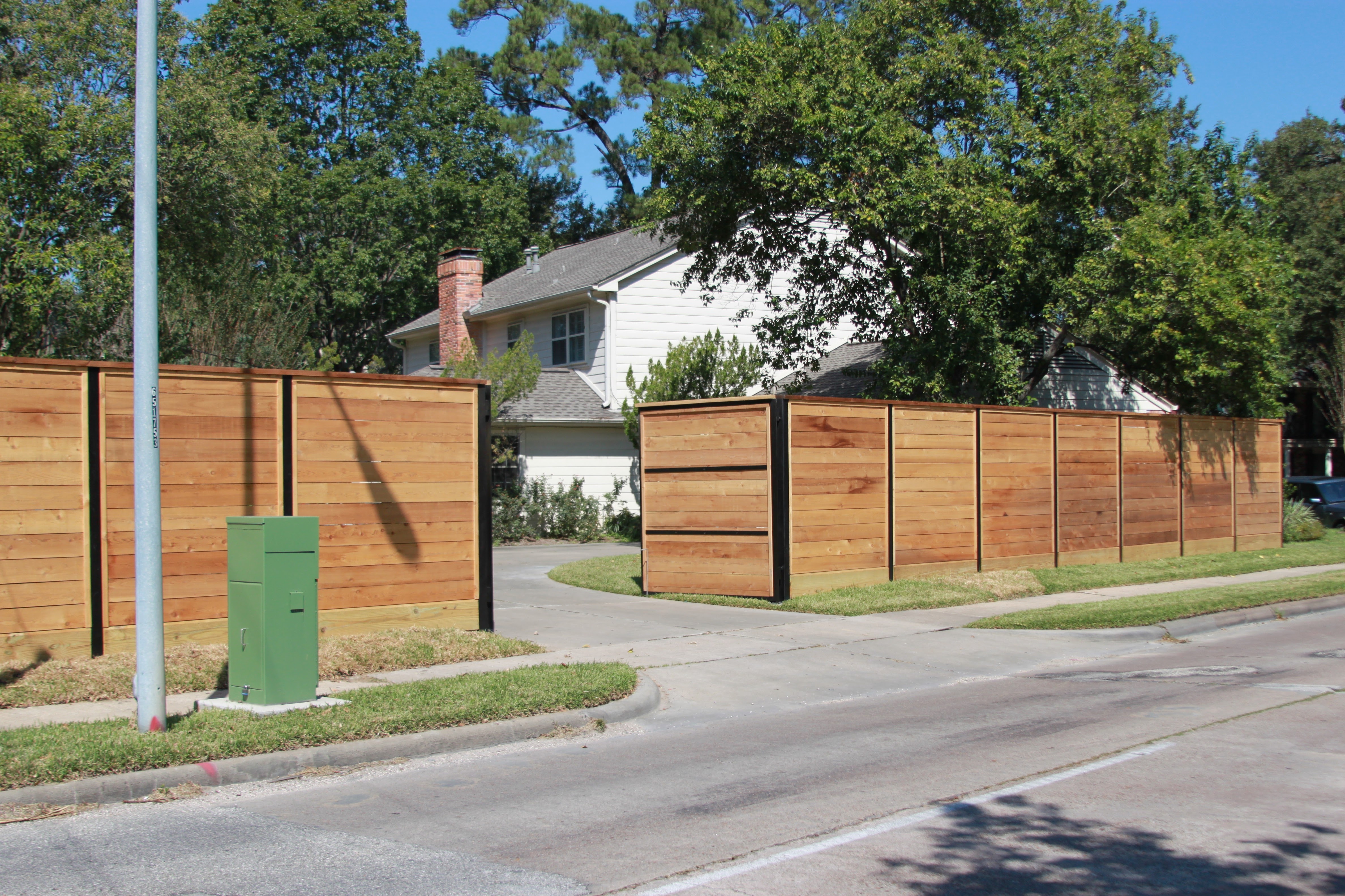 Steel post and railing on horizontal fence — Griffin Fence Houston, TX